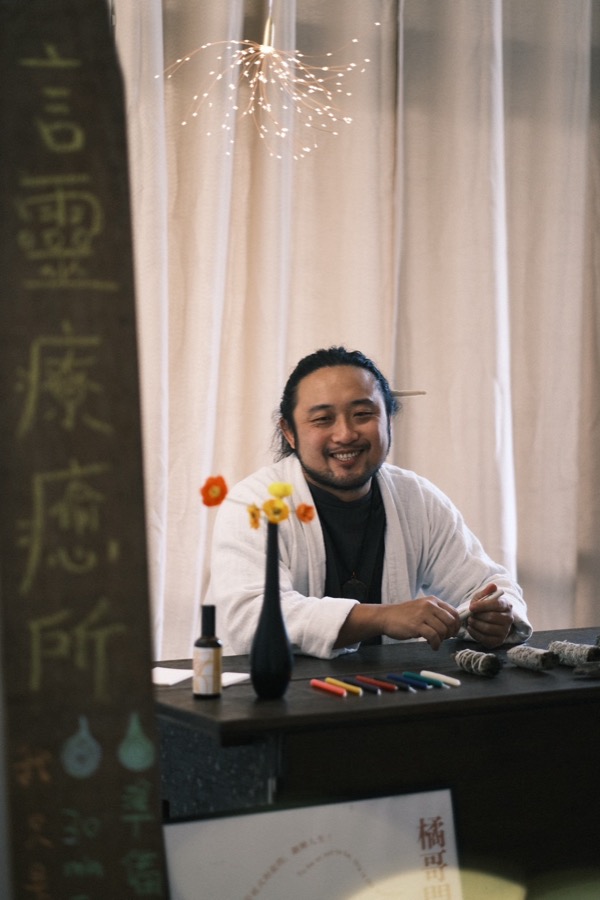 橘哥在問事攤前笑著